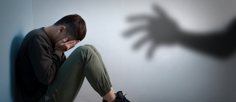 Understanding Anxiety in Adulthood. Young man hiding his face